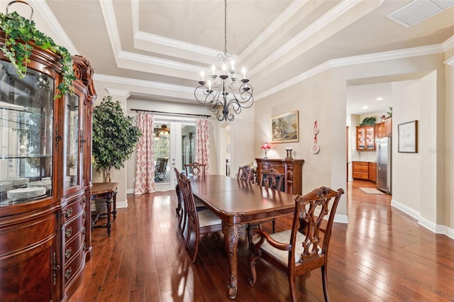 16039 Ternglade Dr, Lithia, FL 33547 - dining space with dark wood-style floors, baseboards, crown molding, a chandelier, and a tray ceiling