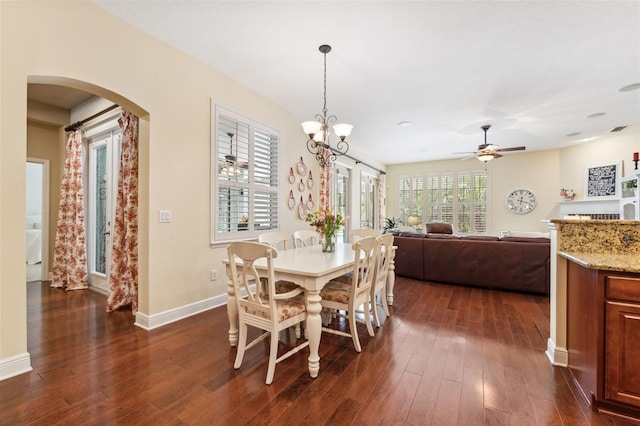 16039 Ternglade Dr, Lithia, FL 33547 - dining room featuring arched walkways, dark wood finished floors, baseboards, and ceiling fan