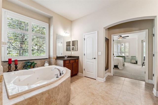 16039 Ternglade Dr, Lithia, FL 33547 - bathroom with a whirlpool tub, vanity, tile patterned floors, baseboards, and ceiling fan