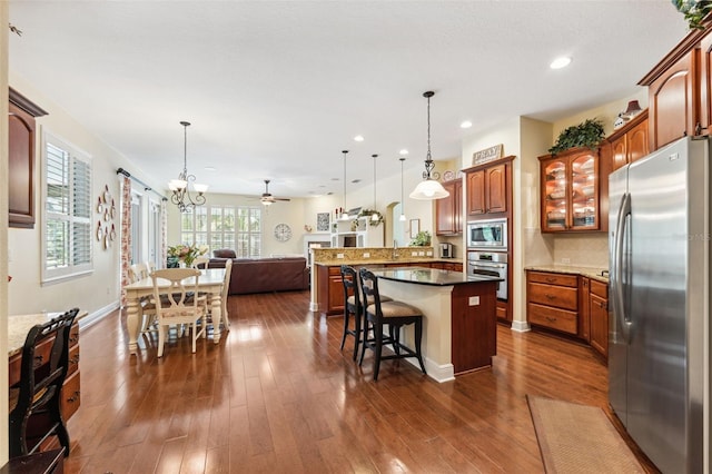 16039 Ternglade Dr, Lithia, FL 33547 - kitchen featuring stainless steel appliances, open floor plan, a kitchen bar, a peninsula, and backsplash