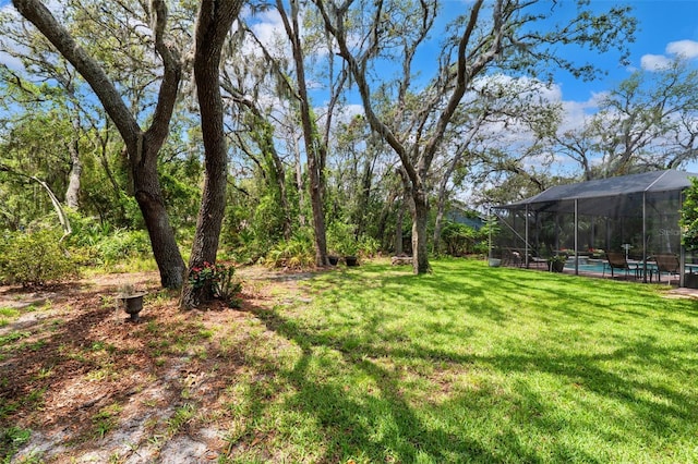 16039 Ternglade Dr, Lithia, FL 33547 - view of grassy yard with an outdoor pool and a lanai