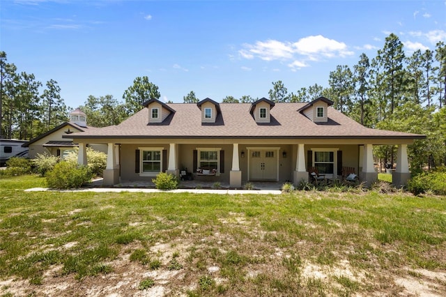 12090 Thames Ave, Weeki Wachee, FL 34614 - view of front of property with stucco siding, a porch, a front yard, and a shingled roof