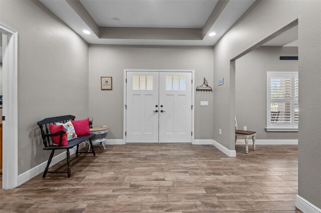 12090 Thames Ave, Weeki Wachee, FL 34614 - foyer featuring wood finished floors, recessed lighting, baseboards, and a tray ceiling