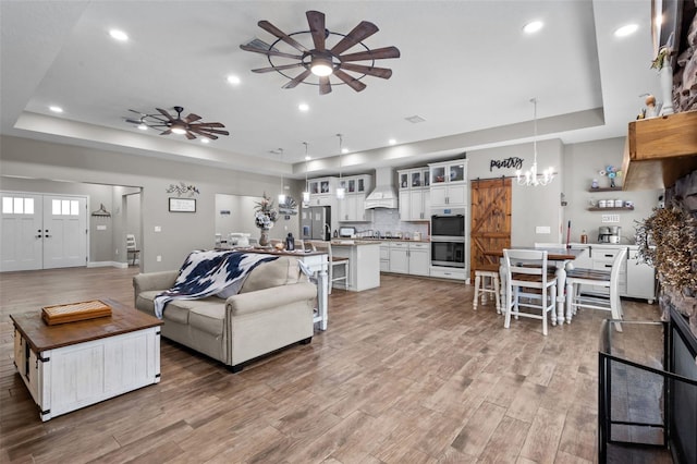 12090 Thames Ave, Weeki Wachee, FL 34614 - living room with a raised ceiling, a ceiling fan, a chandelier, and recessed lighting