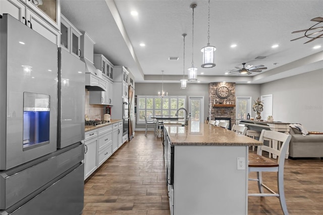 12090 Thames Ave, Weeki Wachee, FL 34614 - kitchen with appliances with stainless steel finishes, open floor plan, a breakfast bar area, recessed lighting, and a raised ceiling