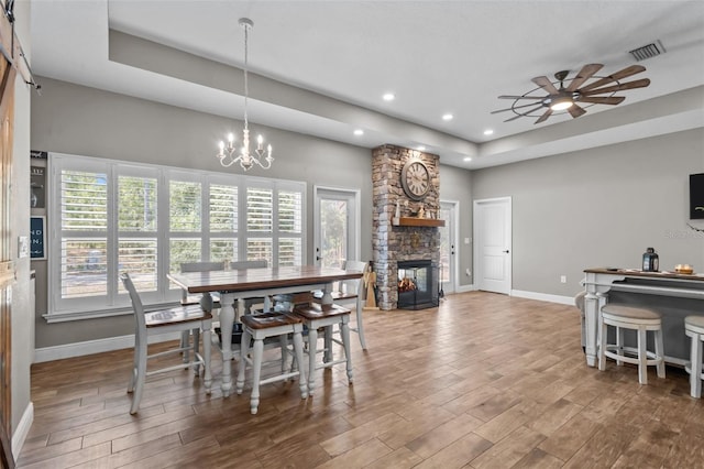 12090 Thames Ave, Weeki Wachee, FL 34614 - dining room featuring a tray ceiling, baseboards, ceiling fan, wood finished floors, and recessed lighting