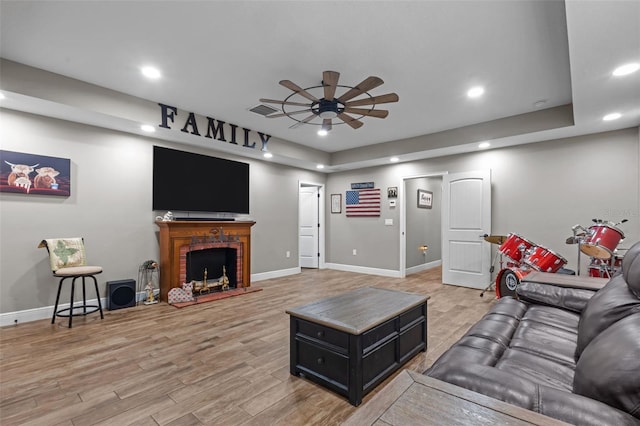 12090 Thames Ave, Weeki Wachee, FL 34614 - living room featuring ceiling fan, recessed lighting, light wood-style flooring, baseboards, and a fireplace