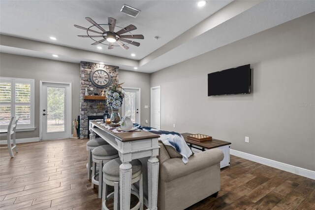 12090 Thames Ave, Weeki Wachee, FL 34614 - living area with a ceiling fan, dark wood-type flooring, baseboards, recessed lighting, and a stone fireplace