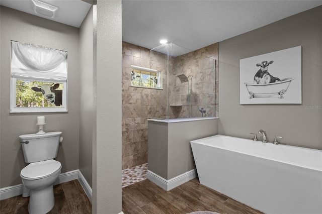 12090 Thames Ave, Weeki Wachee, FL 34614 - full bath with a freestanding bath, wood finished floors, a walk in shower, and healthy amount of natural light