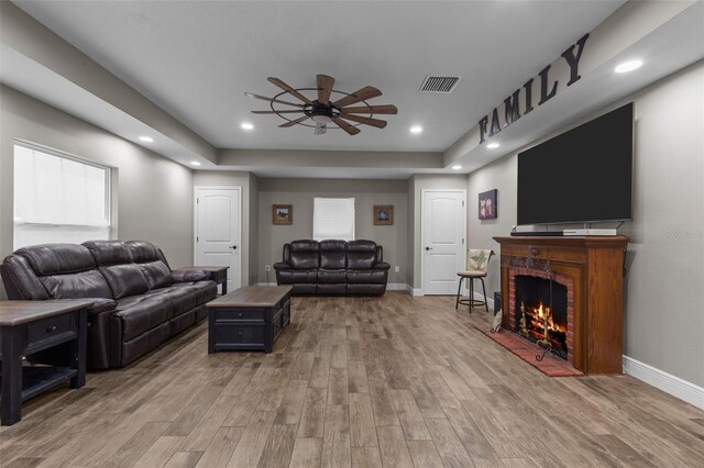 12090 Thames Ave, Weeki Wachee, FL 34614 - living area featuring ceiling fan, light wood-type flooring, baseboards, a fireplace, and recessed lighting