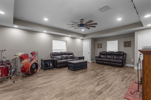 12090 Thames Ave, Weeki Wachee, FL 34614 - living room featuring ceiling fan, wood finished floors, recessed lighting, baseboards, and a raised ceiling