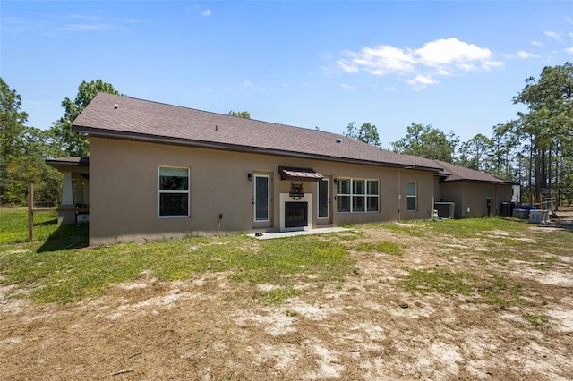 12090 Thames Ave, Weeki Wachee, FL 34614 - rear view of property with stucco siding, central air condition unit, and a shingled roof