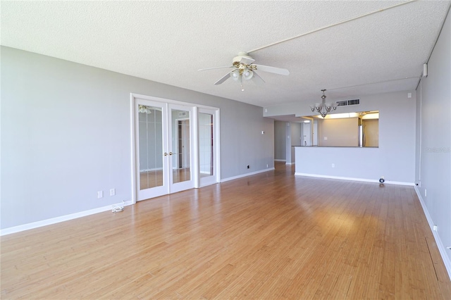 7400 Sun Island Dr S Unit 501, South Pasadena, FL 33707 - unfurnished living room with a chandelier, ceiling fan, french doors, baseboards, and light wood finished floors