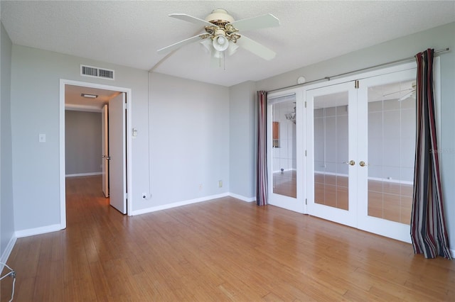7400 Sun Island Dr S Unit 501, South Pasadena, FL 33707 - unfurnished room featuring french doors, wood finished floors, baseboards, and ceiling fan