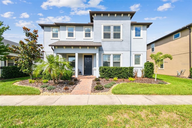 17589 Cruiser Bnd, Land O Lakes, FL 34638 - view of front of property featuring stucco siding, a front lawn, and covered porch