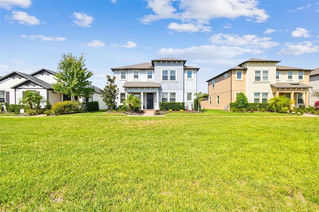 17589 Cruiser Bnd, Land O Lakes, FL 34638 - view of front of house featuring a front yard, a residential view, and stucco siding