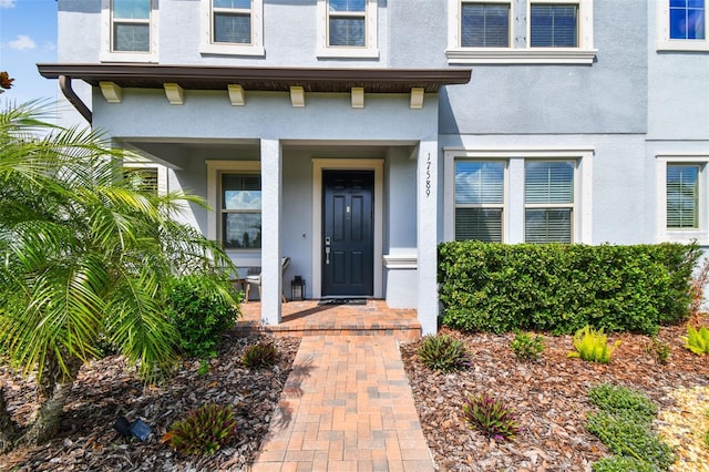 17589 Cruiser Bnd, Land O Lakes, FL 34638 - entrance to property with stucco siding and covered porch