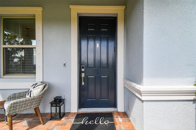 17589 Cruiser Bnd, Land O Lakes, FL 34638 - view of exterior entry featuring stucco siding and covered porch