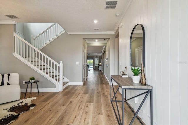 17589 Cruiser Bnd, Land O Lakes, FL 34638 - entrance foyer with ornamental molding, wood finished floors, stairs, and baseboards