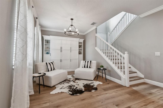 17589 Cruiser Bnd, Land O Lakes, FL 34638 - entryway with crown molding, a chandelier, wood finished floors, stairway, and baseboards