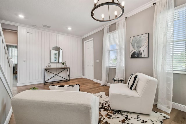 17589 Cruiser Bnd, Land O Lakes, FL 34638 - living area with ornamental molding, plenty of natural light, baseboards, wood finished floors, and recessed lighting