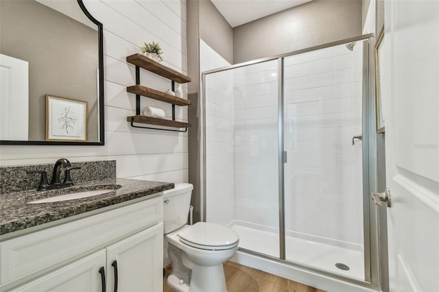 17589 Cruiser Bnd, Land O Lakes, FL 34638 - bathroom featuring a stall shower, vanity, toilet, and wood finished floors