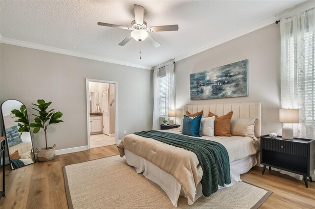17589 Cruiser Bnd, Land O Lakes, FL 34638 - bedroom featuring crown molding, light wood-type flooring, baseboards, ceiling fan, and ensuite bath