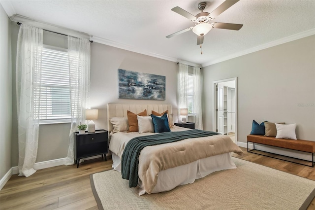 17589 Cruiser Bnd, Land O Lakes, FL 34638 - bedroom with baseboards, light wood-type flooring, crown molding, a ceiling fan, and connected bathroom