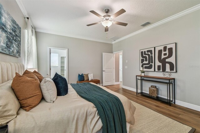 17589 Cruiser Bnd, Land O Lakes, FL 34638 - bedroom with wood finished floors, crown molding, baseboards, and a ceiling fan