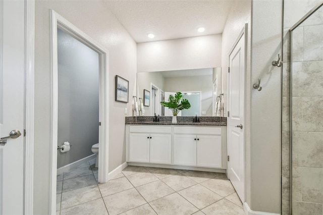 17589 Cruiser Bnd, Land O Lakes, FL 34638 - bathroom with double vanity, tile patterned floors, toilet, a stall shower, and baseboards