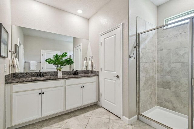 17589 Cruiser Bnd, Land O Lakes, FL 34638 - bathroom featuring double vanity, a shower stall, and tile patterned floors