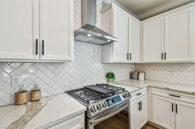 17589 Cruiser Bnd, Land O Lakes, FL 34638 - kitchen featuring wall chimney exhaust hood, stainless steel gas stove, white cabinetry, tasteful backsplash, and crown molding
