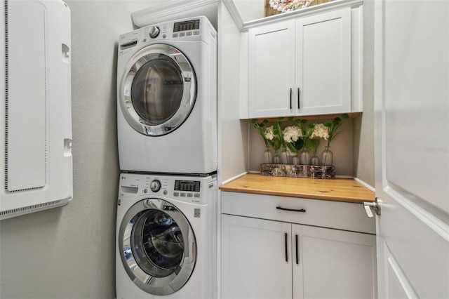 17589 Cruiser Bnd, Land O Lakes, FL 34638 - laundry area with estacked washer and dryer, cabinet space, and a heating unit