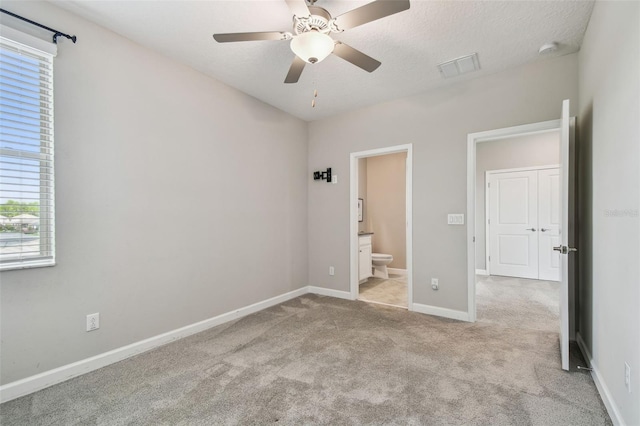 17589 Cruiser Bnd, Land O Lakes, FL 34638 - unfurnished bedroom with multiple windows, carpet, baseboards, and connected bathroom