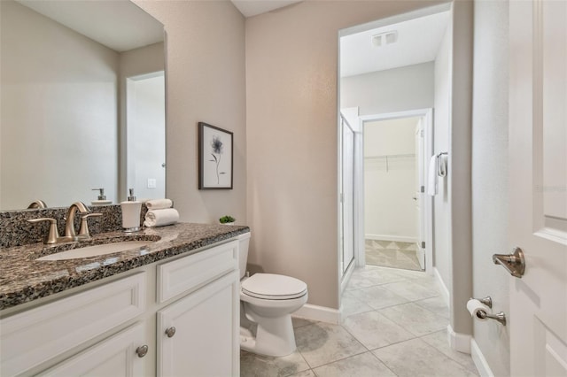 17589 Cruiser Bnd, Land O Lakes, FL 34638 - full bath with vanity, toilet, a stall shower, a spacious closet, and tile patterned flooring