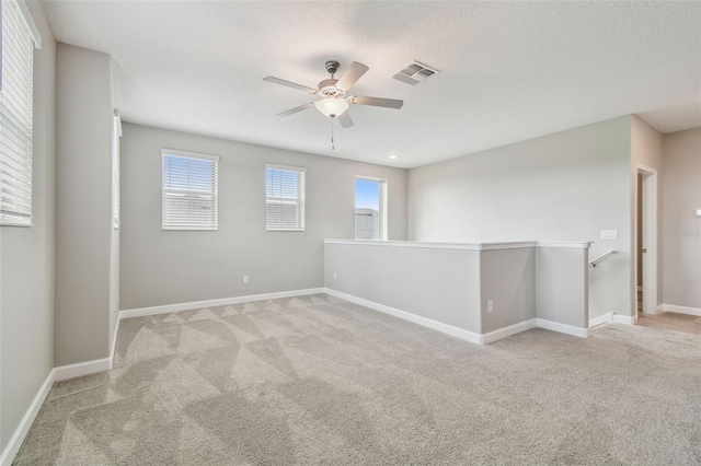 17589 Cruiser Bnd, Land O Lakes, FL 34638 - carpeted empty room featuring a ceiling fan, healthy amount of natural light, baseboards, and a textured ceiling