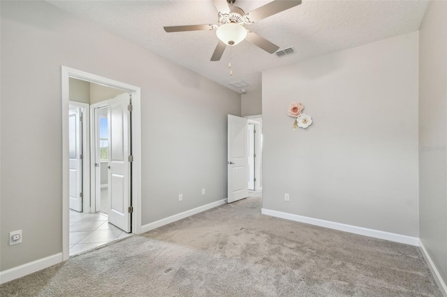 17589 Cruiser Bnd, Land O Lakes, FL 34638 - unfurnished bedroom with carpet floors, a textured ceiling, baseboards, and a ceiling fan