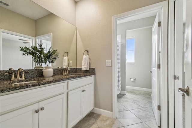 17589 Cruiser Bnd, Land O Lakes, FL 34638 - full bathroom featuring double vanity, tile patterned flooring, and baseboards