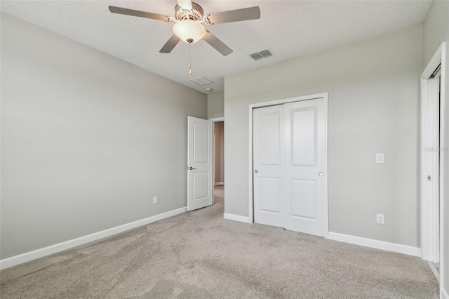 17589 Cruiser Bnd, Land O Lakes, FL 34638 - unfurnished bedroom featuring carpet floors, baseboards, a ceiling fan, a textured ceiling, and a closet