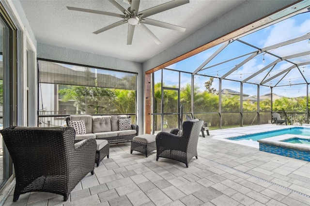 17589 Cruiser Bnd, Land O Lakes, FL 34638 - view of swimming pool with ceiling fan, an outdoor living space, a patio area, glass enclosure, and a pool with connected hot tub