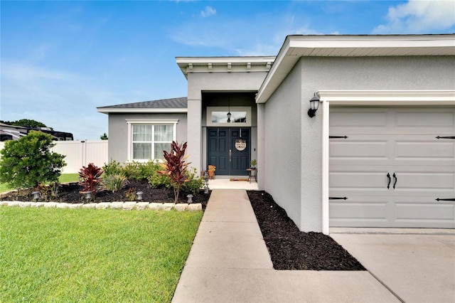 4435 Devinshire Fields Loop, Plant City, FL 33567 - doorway to property with stucco siding and a garage