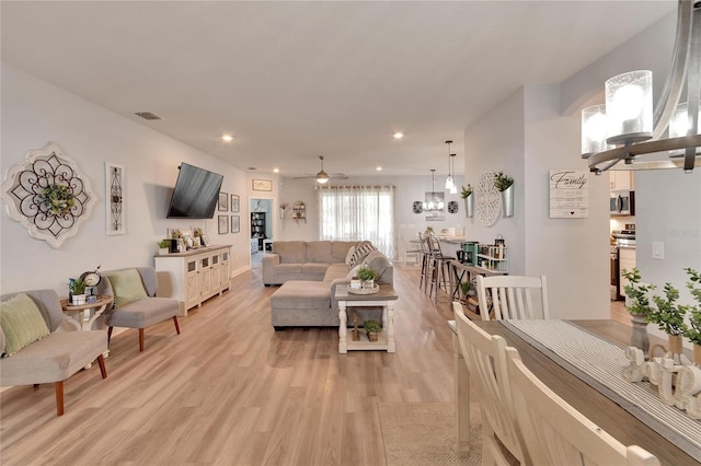 4435 Devinshire Fields Loop, Plant City, FL 33567 - living room featuring light wood-type flooring, ceiling fan, recessed lighting, and a chandelier