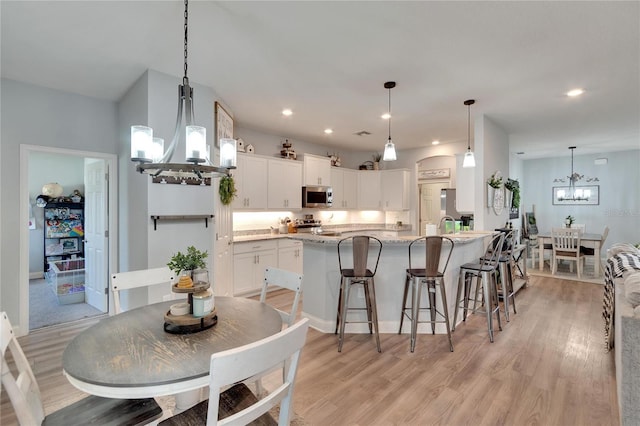4435 Devinshire Fields Loop, Plant City, FL 33567 - dining space with a chandelier, light wood-style floors, and recessed lighting