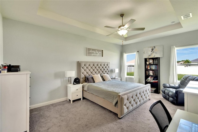 4435 Devinshire Fields Loop, Plant City, FL 33567 - bedroom with a tray ceiling, light carpet, baseboards, and ceiling fan