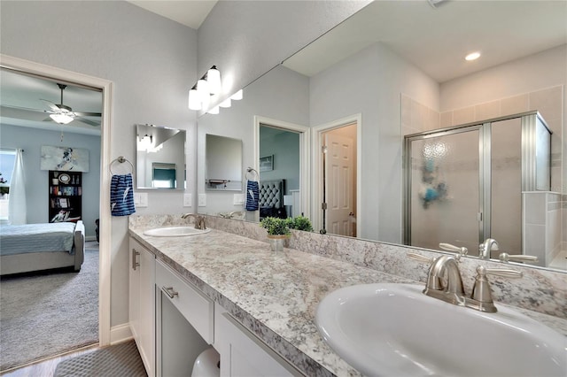 4435 Devinshire Fields Loop, Plant City, FL 33567 - bathroom with ensuite bath, a shower stall, double vanity, a ceiling fan, and baseboards