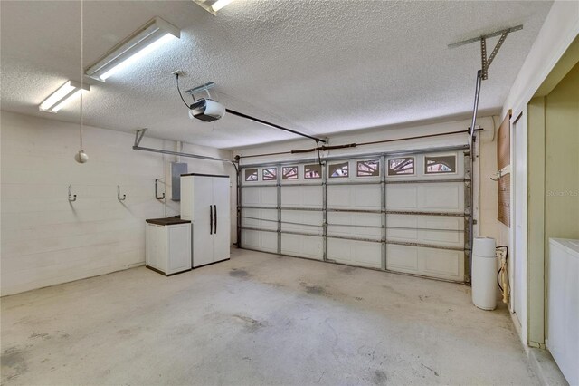 2527 Wrencrest Cir, Valrico, FL 33594 - garage with white refrigerator, a garage door opener, and electric panel