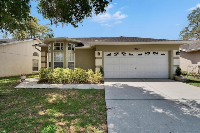 2527 Wrencrest Cir, Valrico, FL 33594 - view of front facade featuring a garage, concrete driveway, stucco siding, and a shingled roof