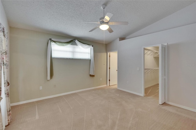 2527 Wrencrest Cir, Valrico, FL 33594 - unfurnished bedroom with light carpet, a ceiling fan, a textured ceiling, vaulted ceiling, and a spacious closet