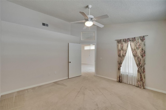 2527 Wrencrest Cir, Valrico, FL 33594 - unfurnished room with light carpet, a ceiling fan, a textured ceiling, baseboards, and a towering ceiling