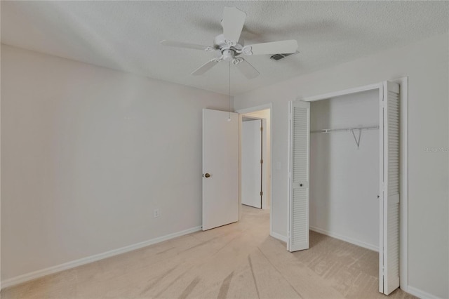 2527 Wrencrest Cir, Valrico, FL 33594 - unfurnished bedroom with carpet flooring, a closet, baseboards, ceiling fan, and a textured ceiling